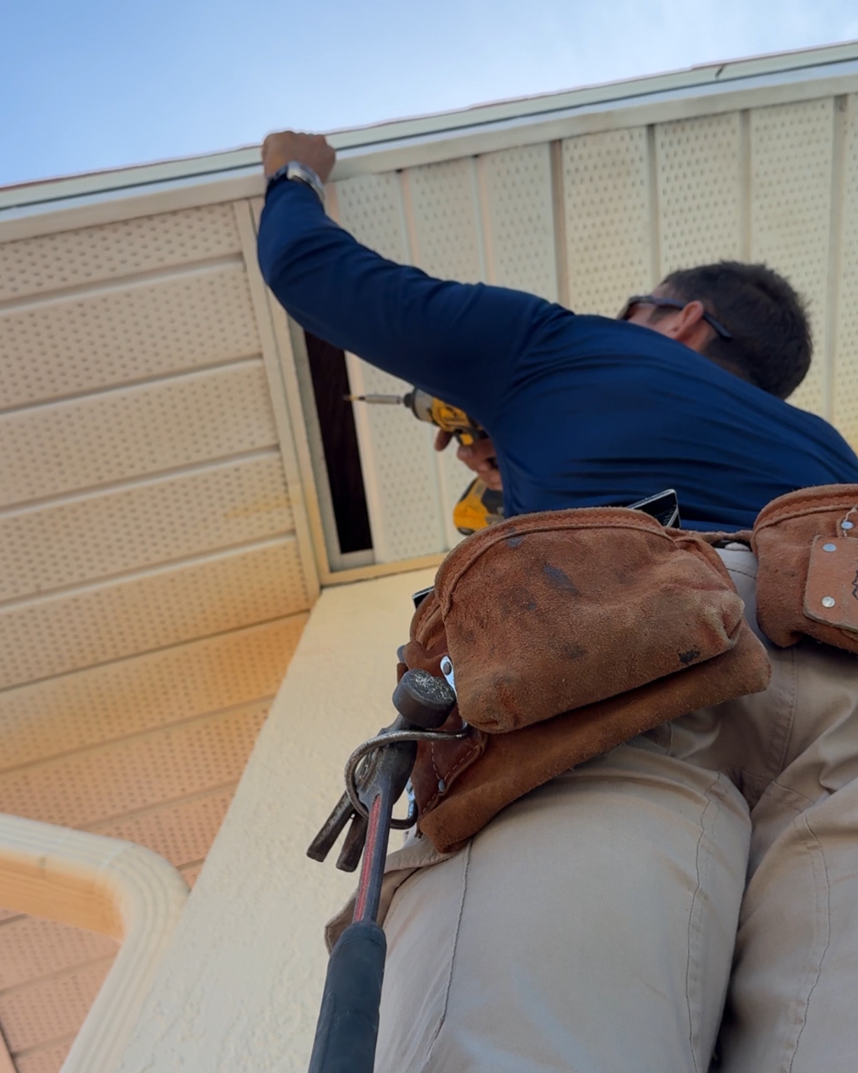 Owner installing aluminum soffit on a Clearwater home